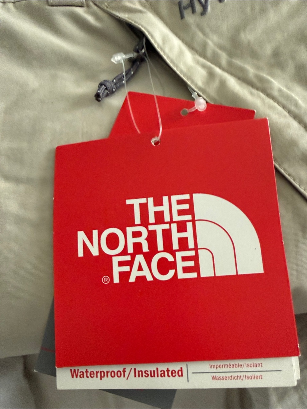 The North Face tan men's pants with red branded tag